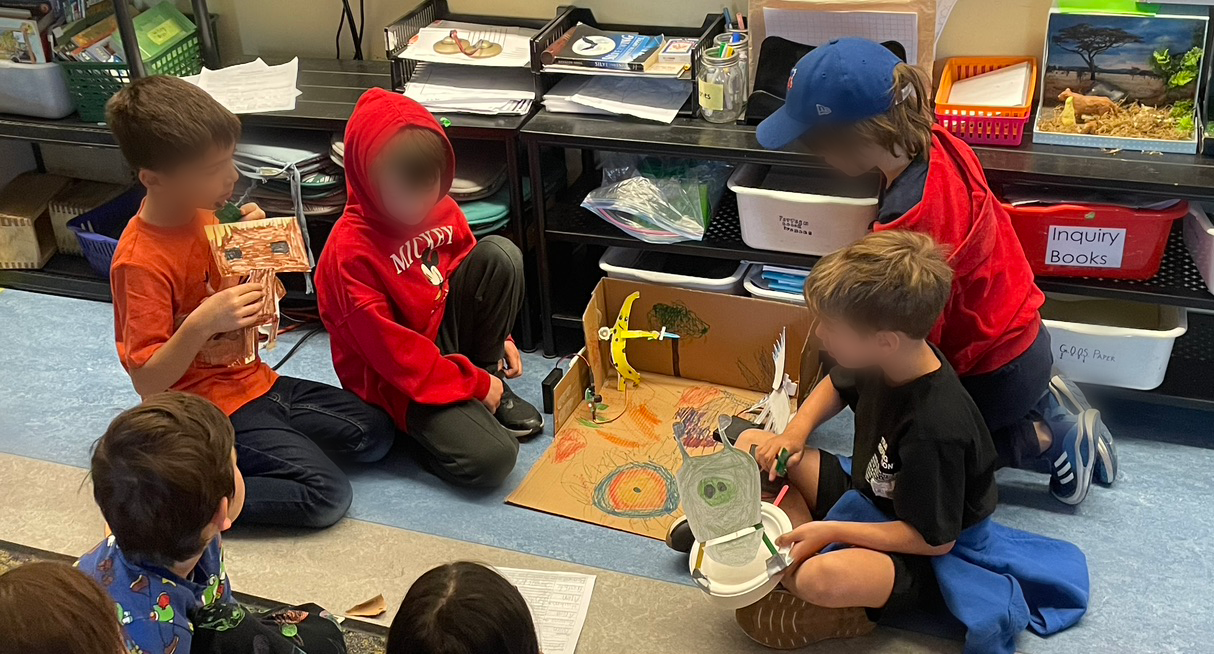 students performing a paper animatronics puppet show